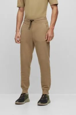 Cuffed tracksuit bottoms in French terry with logo badge